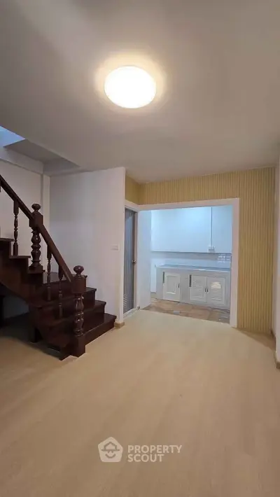 Spacious interior with wooden staircase and modern kitchen area