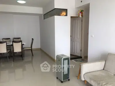 Spacious living room with modern dining area and cozy seating.