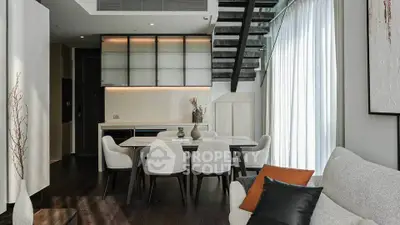Modern living room with elegant dining area and stylish staircase