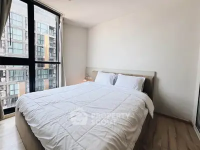 Modern bedroom with large window and cozy bed in urban apartment