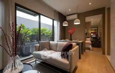 Modern living room with elegant decor and large window opening to a lush balcony view.