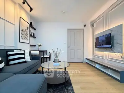 Modern living room with stylish decor, sleek furniture, and wall-mounted TV, perfect for contemporary urban living.