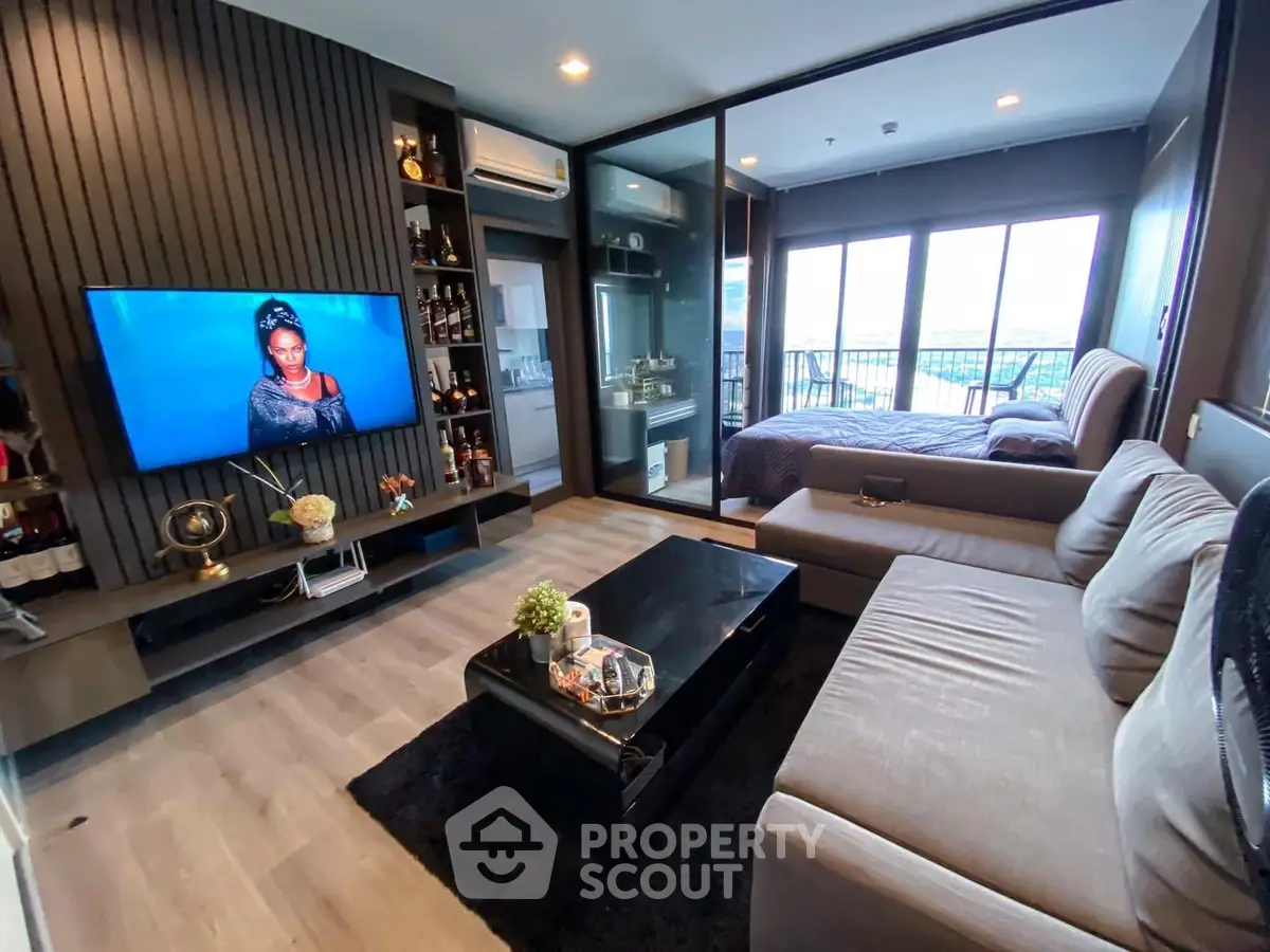 Modern living room with sleek design and cozy bedroom view