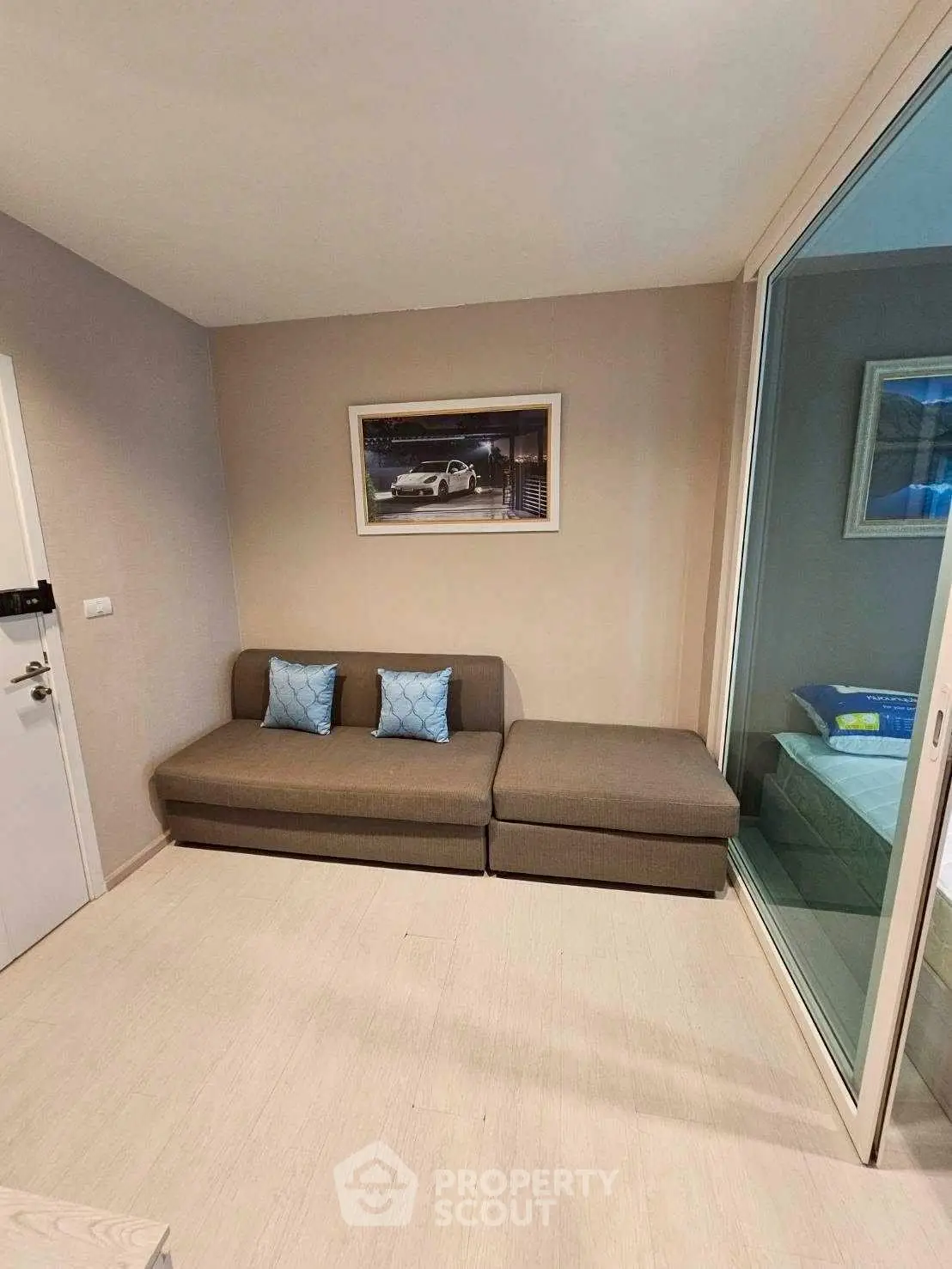 Cozy living room with modern sofa and glass partition, perfect for urban living.