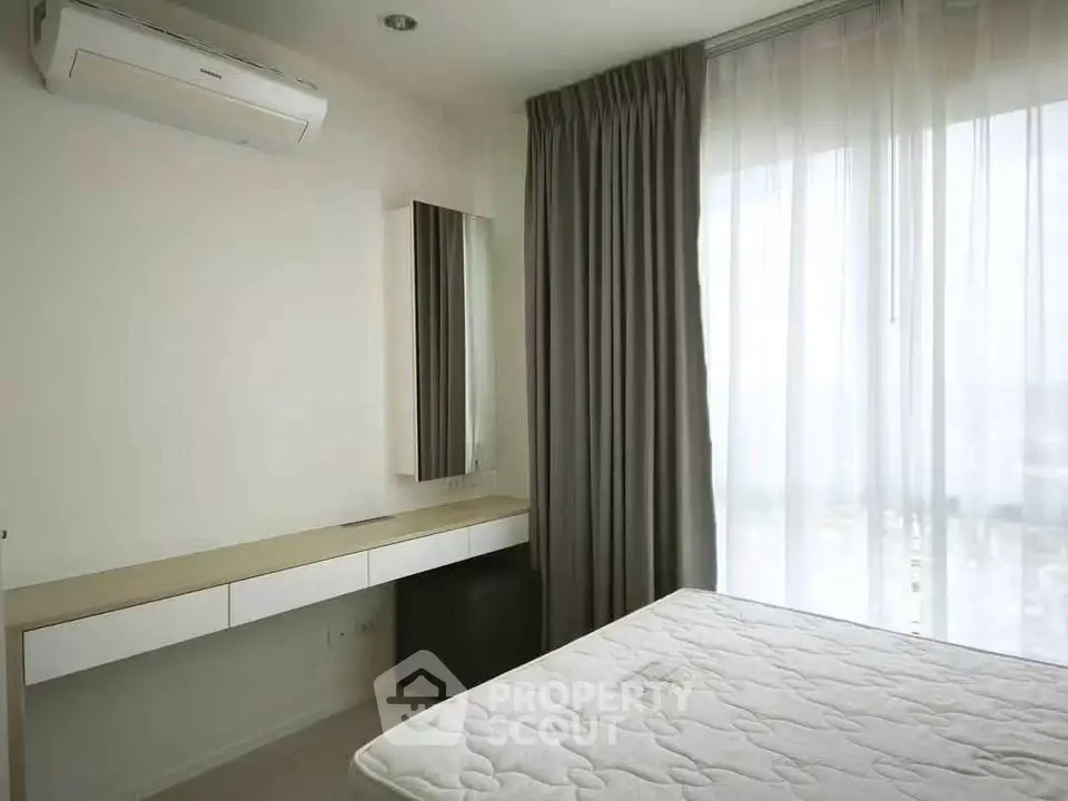Modern bedroom with large window and air conditioning in a stylish apartment.