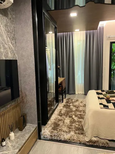 Stylish bedroom with modern decor and large mirrored wardrobe