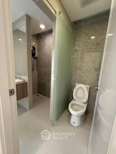 Modern bathroom with glass door and sleek fixtures