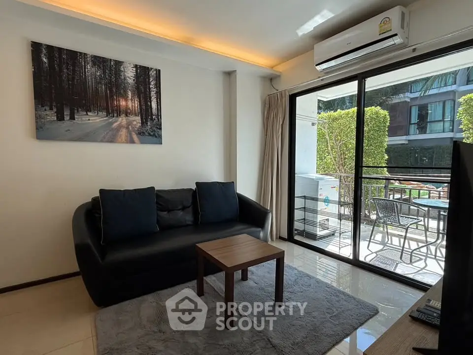 Modern living room with sleek black sofa, large window, and balcony view in stylish apartment.