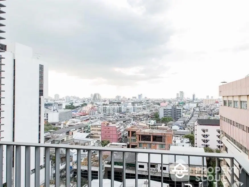 Stunning cityscape view from a high-rise balcony, showcasing urban skyline and vibrant architecture.