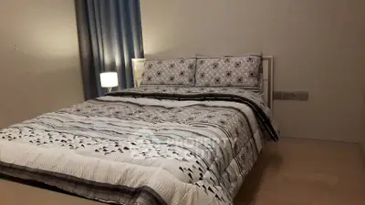 Cozy bedroom with stylish bedding and soft lighting, perfect for relaxation and comfort.