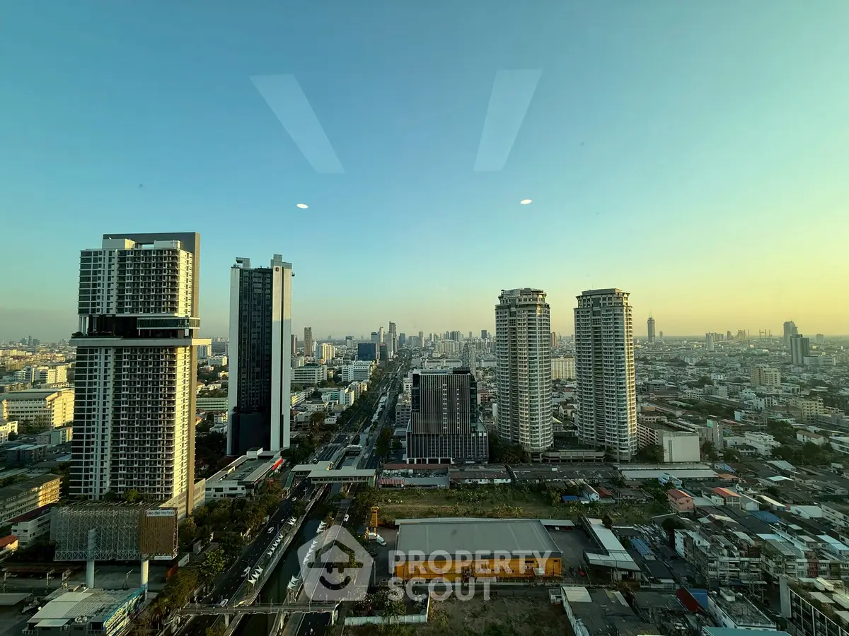 Stunning cityscape view from high-rise building at sunset, showcasing urban skyline and architecture.