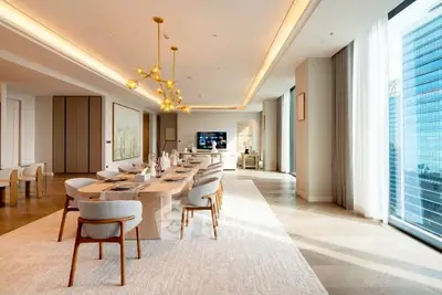 Luxurious open-plan living and dining area with modern decor and city view.