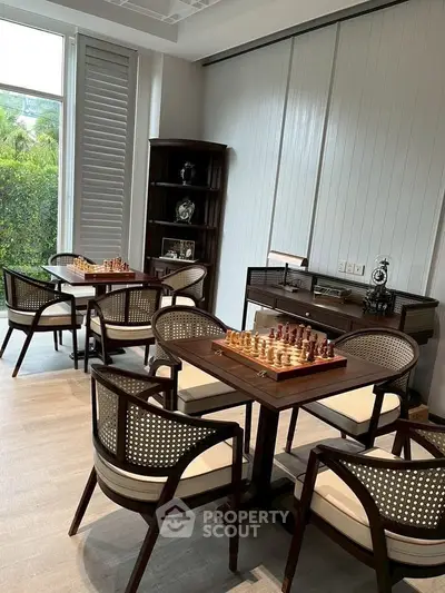 Luxurious study room with chess tables and elegant seating, perfect for intellectual gatherings.