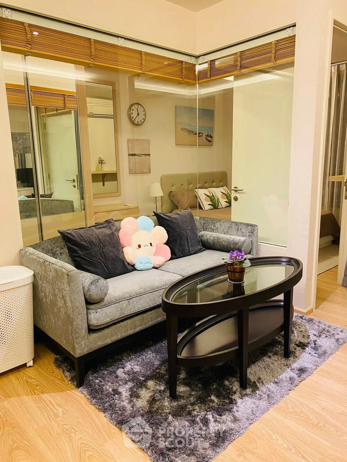 Chic living room with plush sofa and glass coffee table in modern apartment