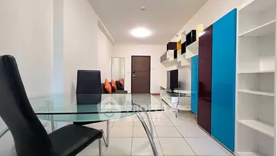 Modern living room with sleek furniture and vibrant decor in a stylish apartment.