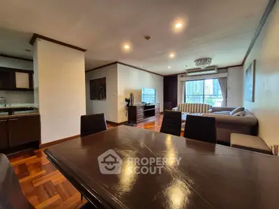 Spacious living room with elegant dining area and city view, perfect for modern urban living.