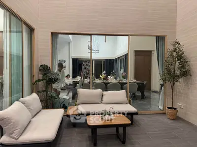 Elegant modern living area with stylish furniture and large glass windows.