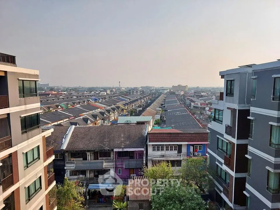 Stunning aerial view of urban residential area with modern buildings and vibrant rooftops.