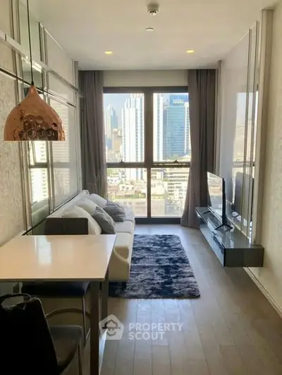 Modern living room with city view, stylish decor, and natural light in a high-rise apartment.