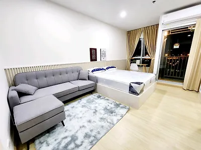 Modern studio apartment with cozy living area and balcony view