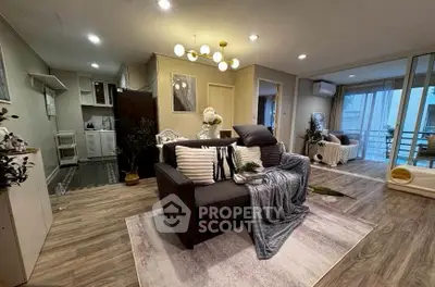 Stylish modern living room with cozy seating and elegant decor in a spacious apartment.