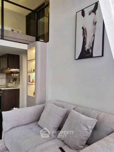 Modern living room with stylish decor and open kitchen layout in a contemporary apartment.