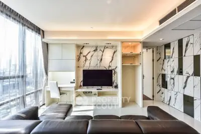 Luxurious modern living room with marble accents and large windows