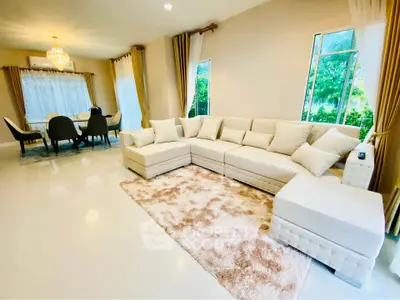 Spacious living room with elegant decor and large windows for natural light.