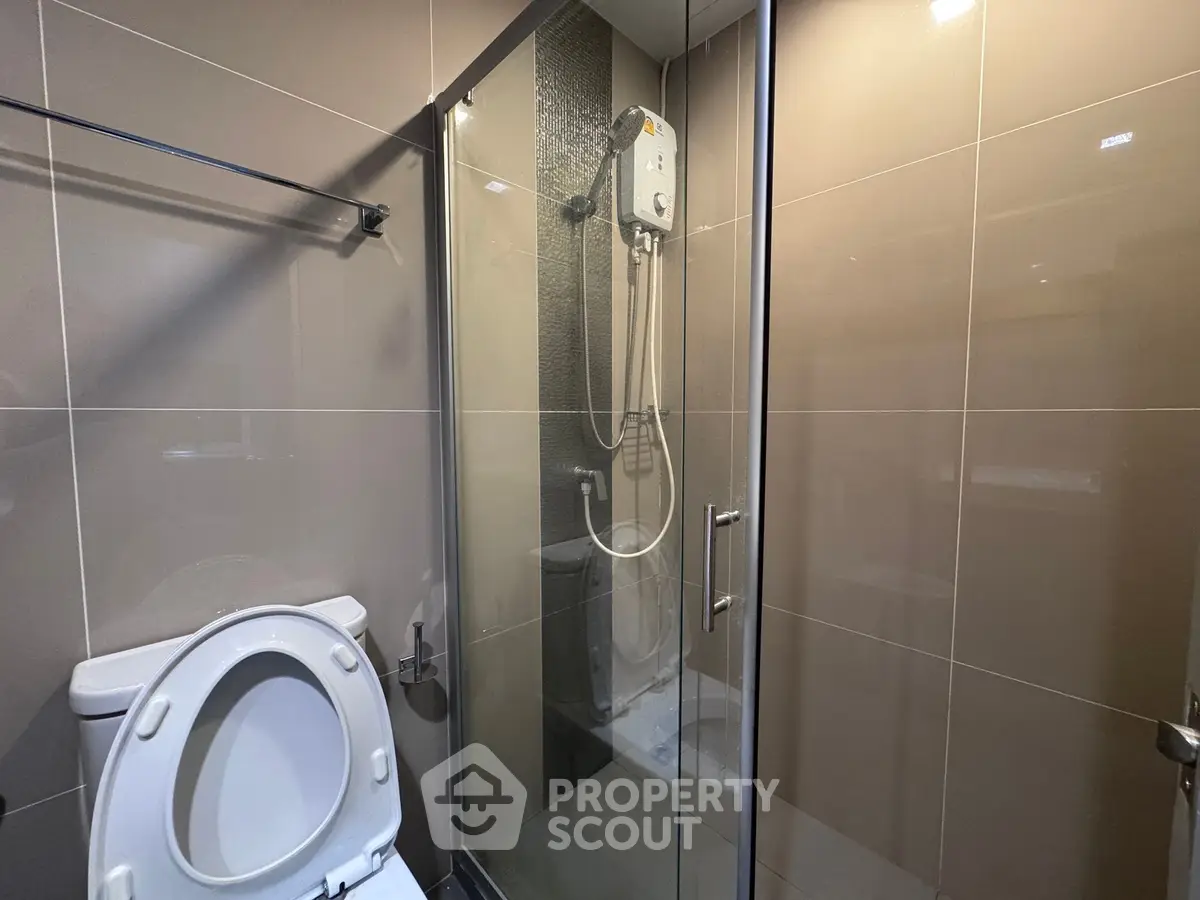 Modern bathroom with glass shower enclosure and sleek tile design