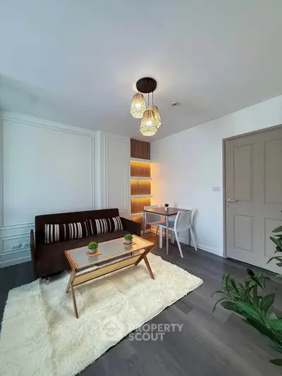 Modern living room with stylish decor, cozy seating, and elegant lighting in a contemporary apartment.