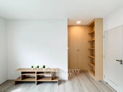 Modern minimalist living room with wooden flooring and built-in storage