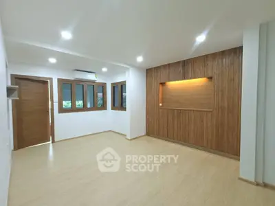 Spacious modern living room with wooden accents and recessed lighting