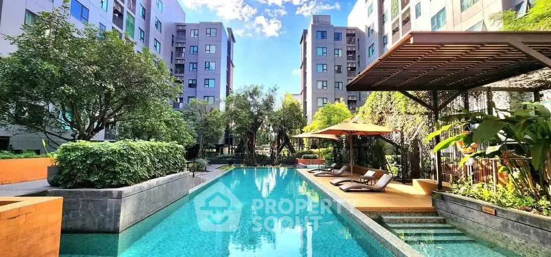 Luxurious apartment complex with stunning pool and lush greenery