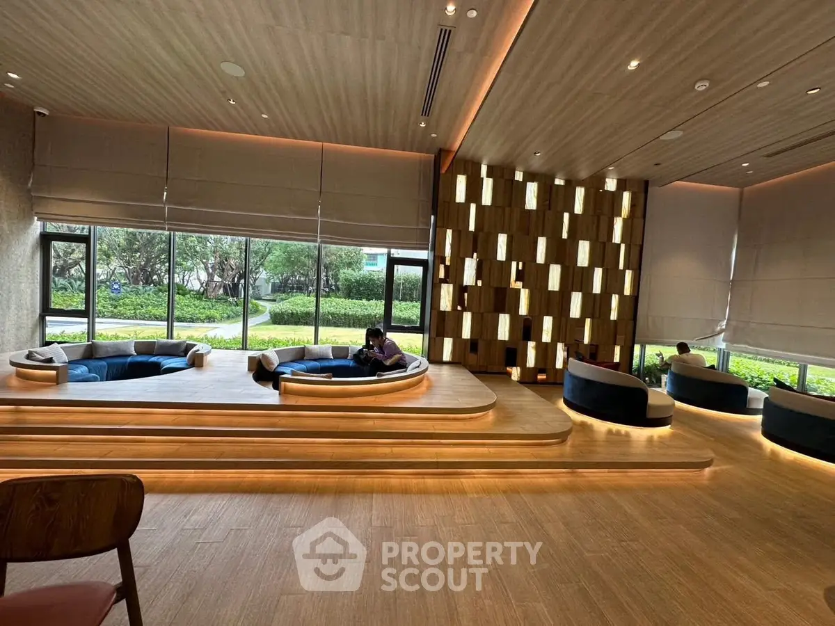 Luxurious modern living room with unique seating and large windows overlooking a lush garden.