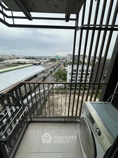 Modern balcony with washing machine and city view, perfect for urban living.
