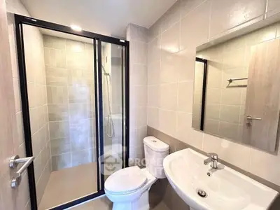 Modern bathroom with glass shower enclosure and sleek fixtures