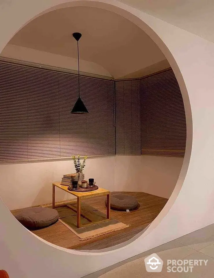 Stylish modern nook with circular opening, cozy seating, and elegant decor for a serene ambiance.