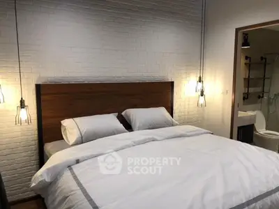 Modern bedroom with stylish lighting and brick accent wall