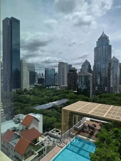 Stunning cityscape view with luxurious rooftop pool and lush greenery.