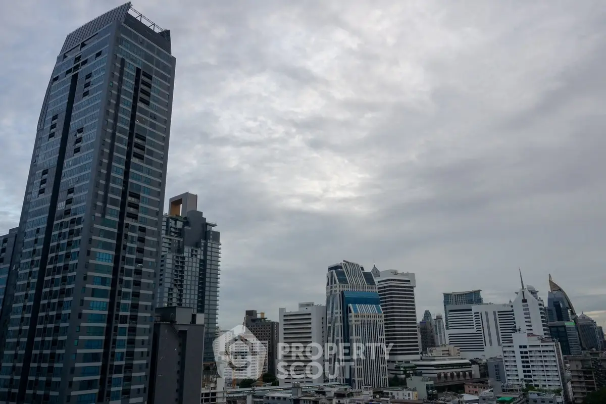 Stunning cityscape view of modern skyscrapers under a cloudy sky, showcasing urban architecture.