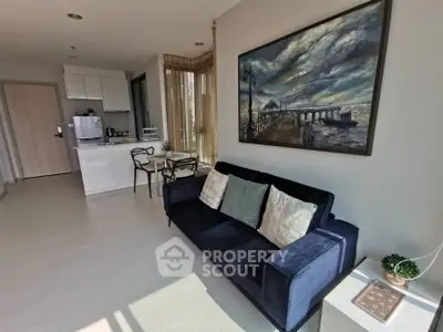 Modern living room with stylish decor and natural light in a contemporary apartment.