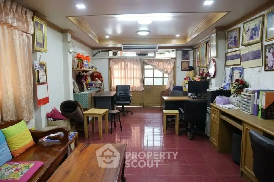Spacious living room with wooden furniture and vibrant decor, ideal for family gatherings.