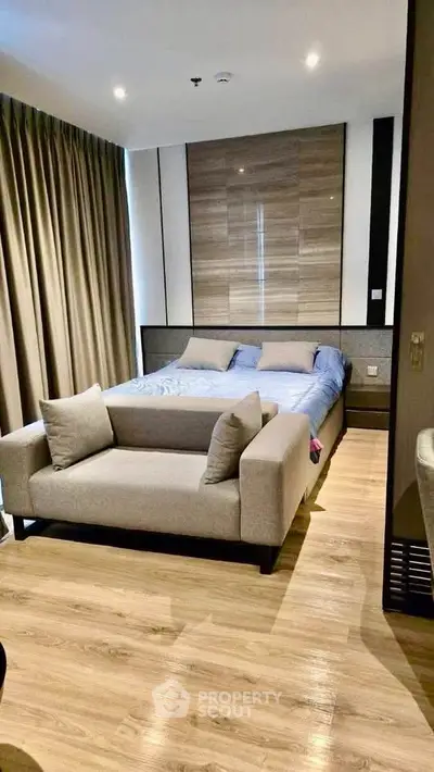 Modern bedroom with stylish decor and cozy ambiance, featuring a comfortable bed and elegant furnishings.