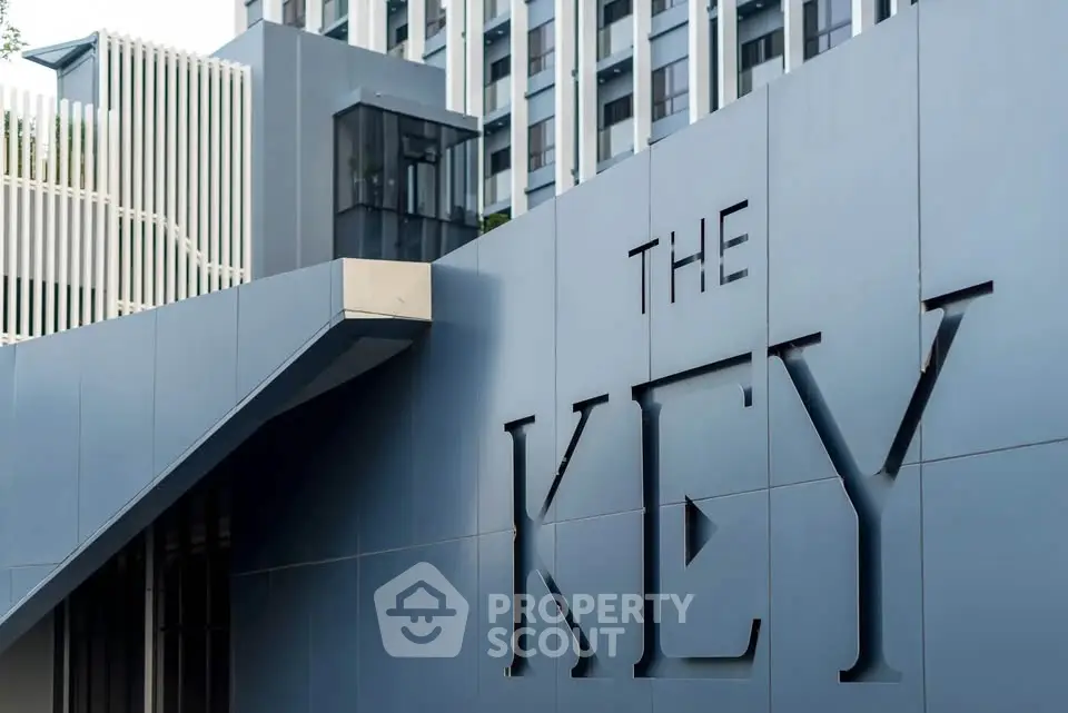 Modern building entrance with sleek architectural design and prominent signage.