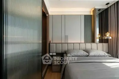 Modern bedroom with sleek design and ambient lighting, featuring a comfortable bed and stylish decor.