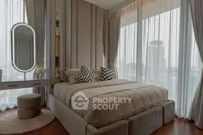 Luxurious bedroom with city view, elegant decor, and plush bedding