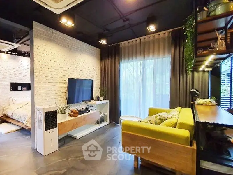 Modern living room with stylish decor and natural light, featuring a cozy seating area and entertainment setup.