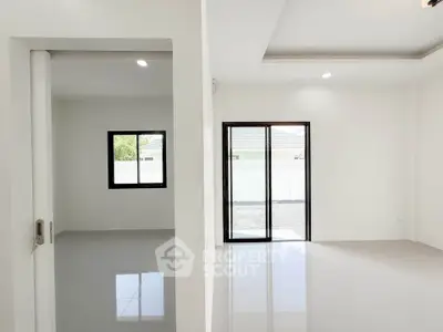 Spacious modern interior with sleek tile flooring and large windows for natural light.