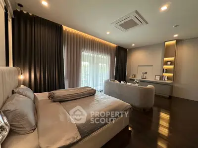 Luxurious bedroom with elegant decor and large windows offering natural light