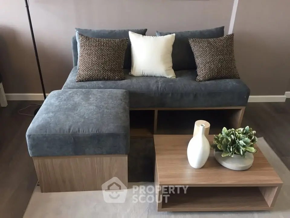 Modern living room with stylish grey sofa and wooden coffee table